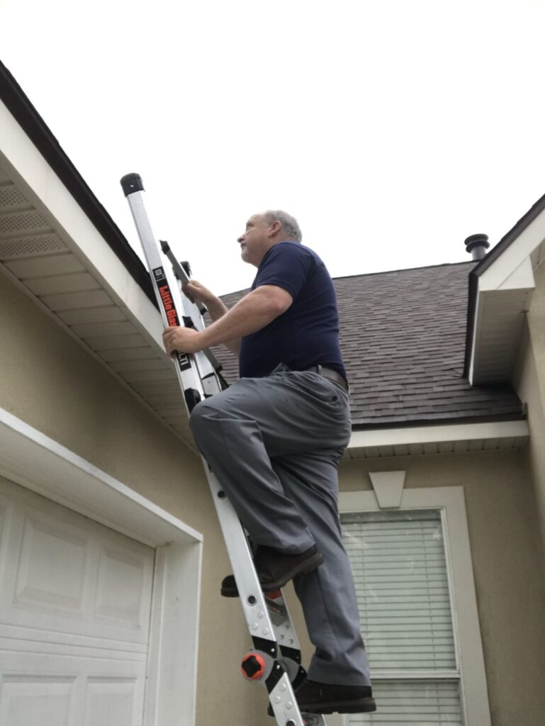 Wade examining the exterior of a home